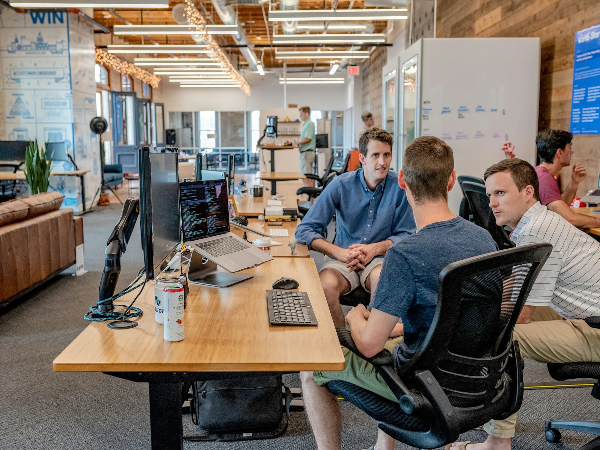 Colleagues in discussion around a table in a professional workspace
