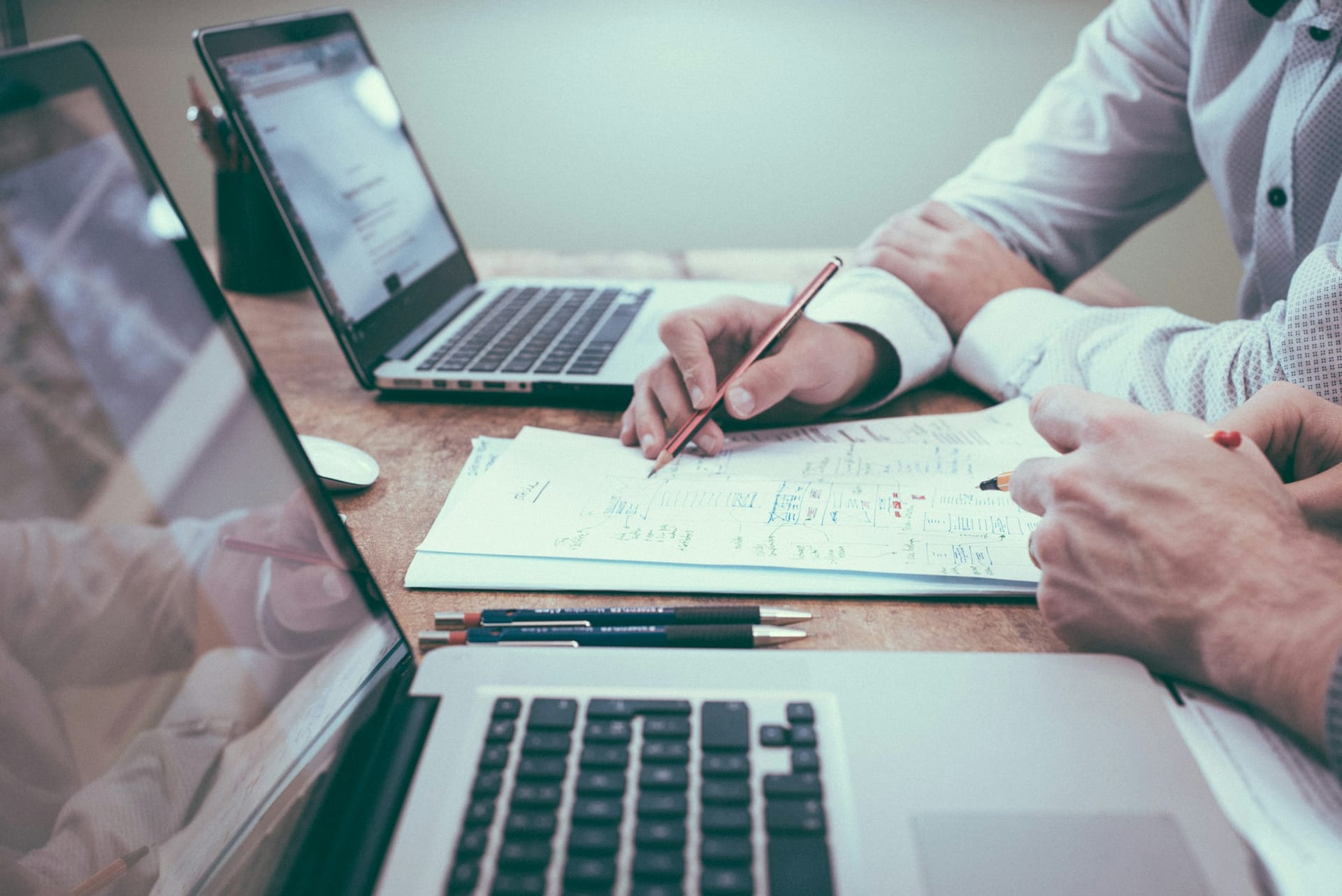 A professional working through planning documents at a desk