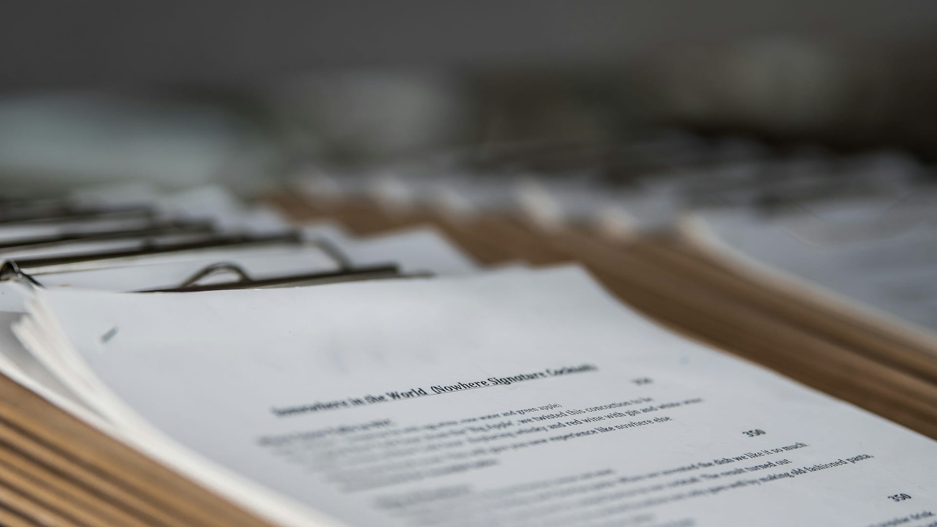 Paperwork and a laptop arranged on a desk during administrative work