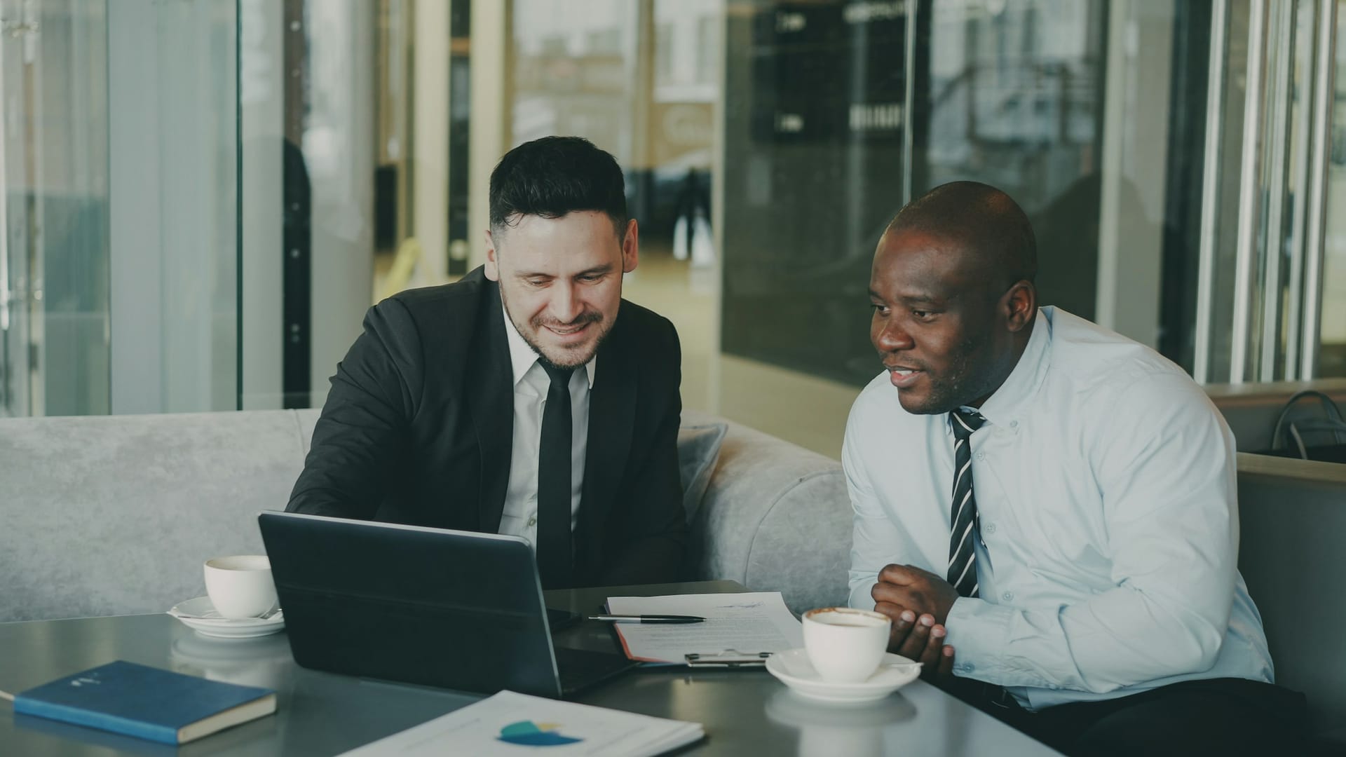 Two professionals in an initial business discussion across a table