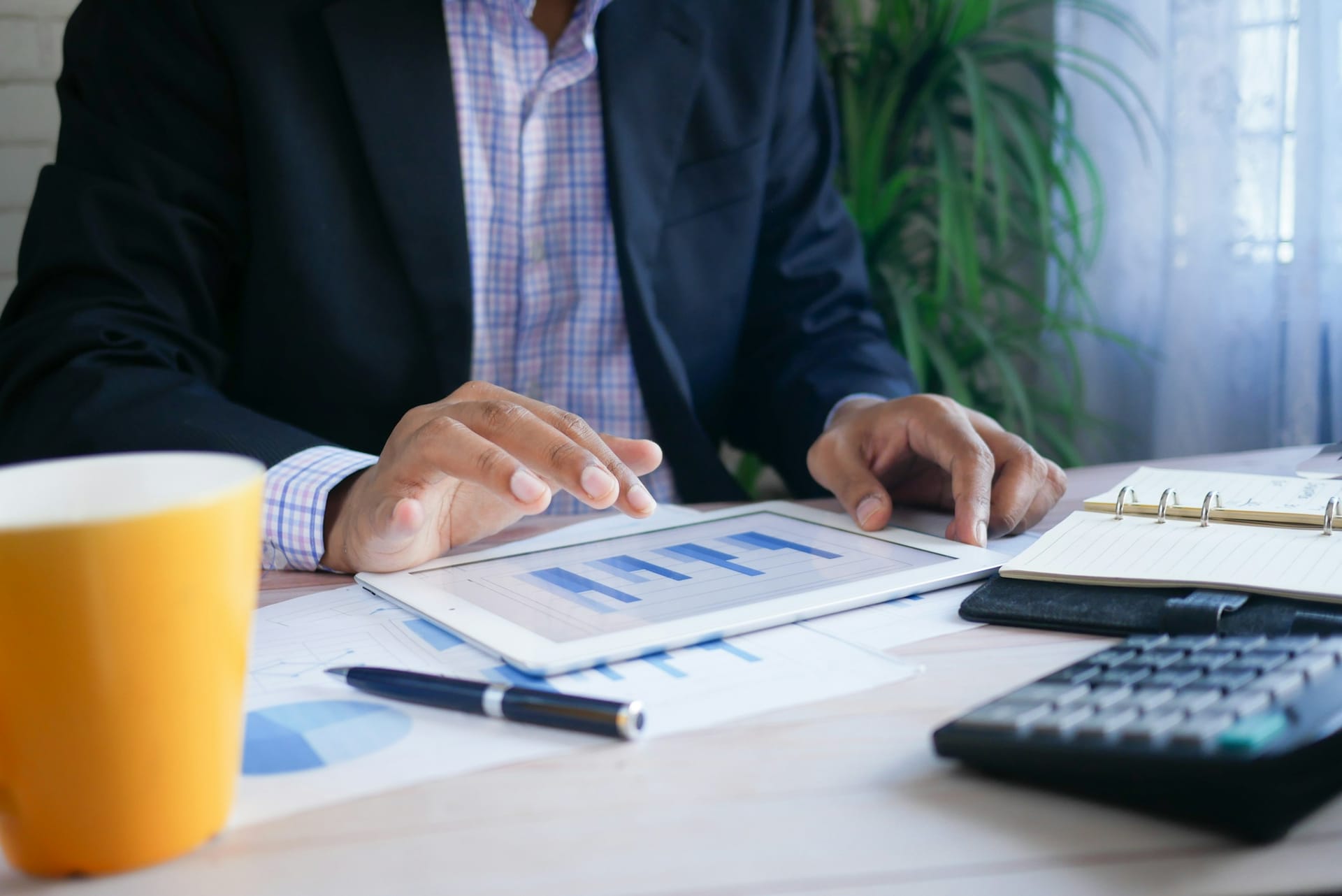 An administrator working through financial paperwork at a desk